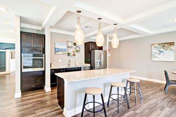 a kitchen with a bar and stools